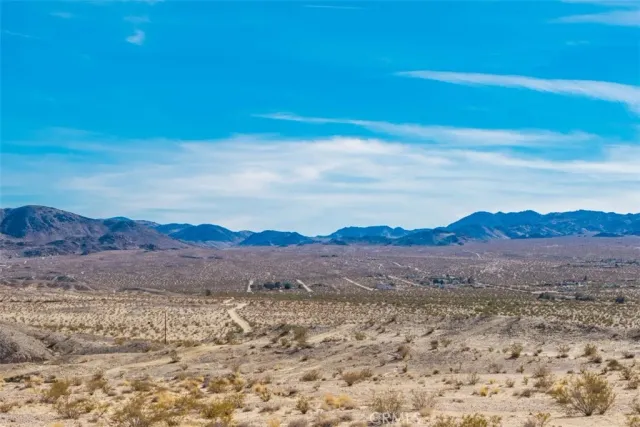 a view of mountain with sunset in background