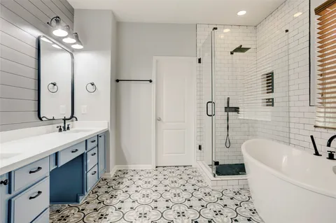 a bathroom with a bathtub sink and mirror