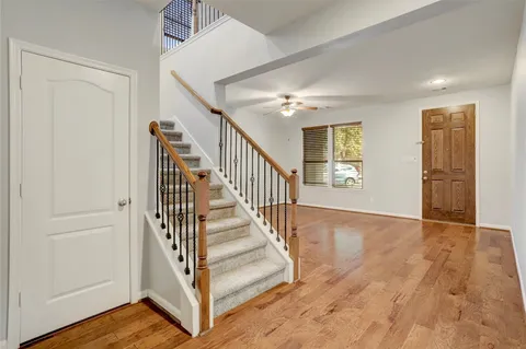 a view of entryway and hall with wooden floor