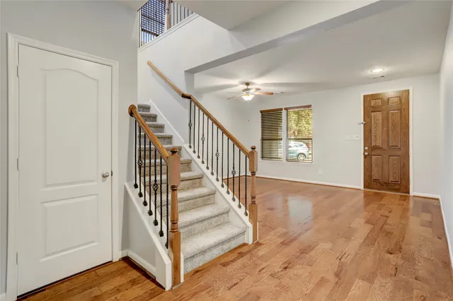 a view of entryway and hall with wooden floor
