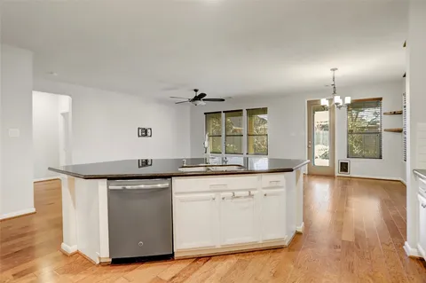 a kitchen with kitchen island a sink a stove and refrigerator