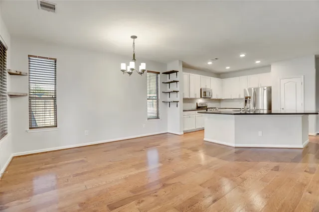 a kitchen with granite countertop a sink and cabinets