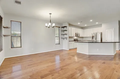 a kitchen with granite countertop a sink and cabinets