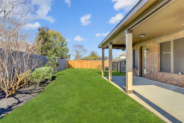 a view of a house with a yard and deck