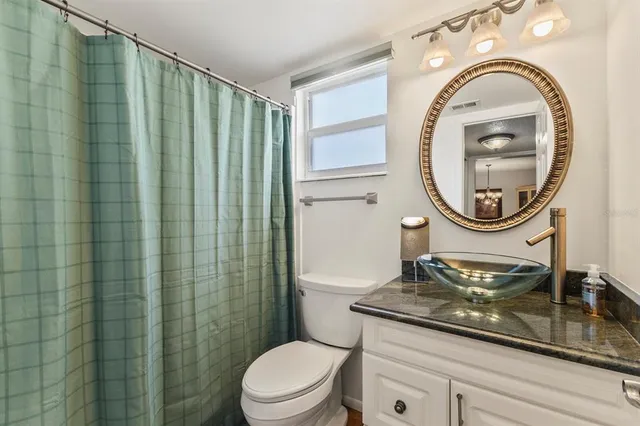 a bathroom with a sink a mirror and a toilet