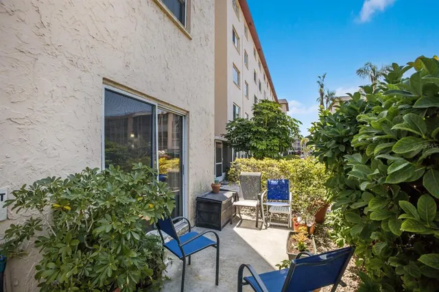 a backyard of a house with outdoor seating