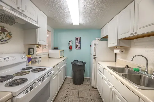 a kitchen with a sink cabinets and appliances
