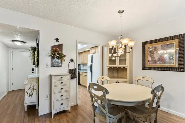 a view of a dining room with furniture and chandelier