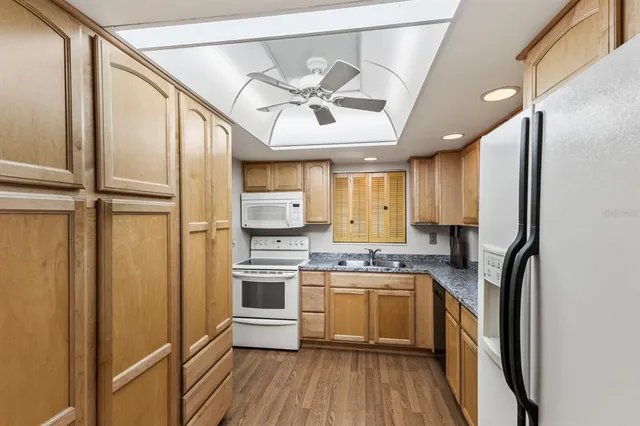 a kitchen with a refrigerator a sink and cabinets