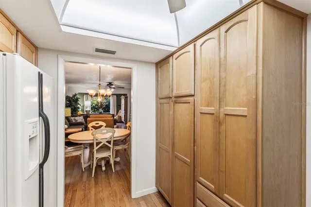 a view of a hallway with furniture and a kitchen view