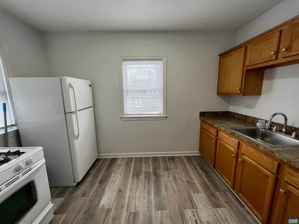 a kitchen with sink a refrigerator and a stove