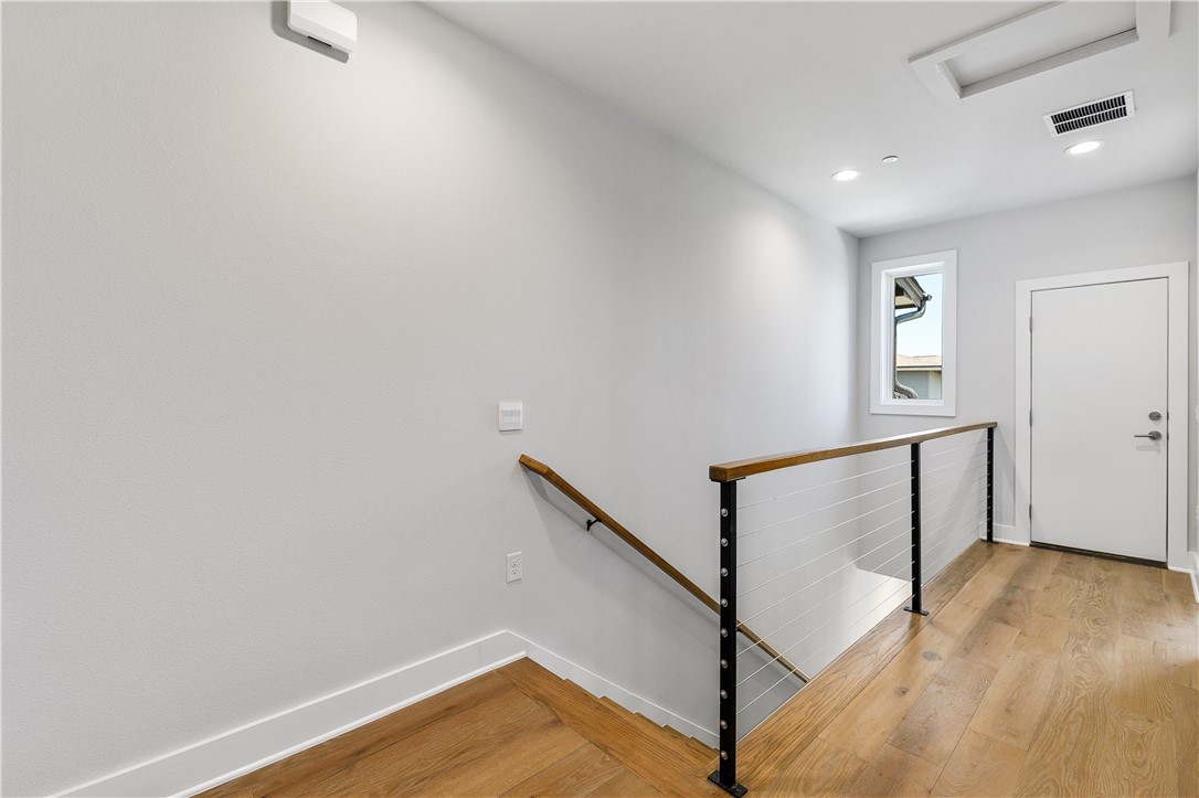 4611 Unity Circle Austin, TX 78731 - Photo 29 of 40 Third floor hall and stairwell down to second floor.