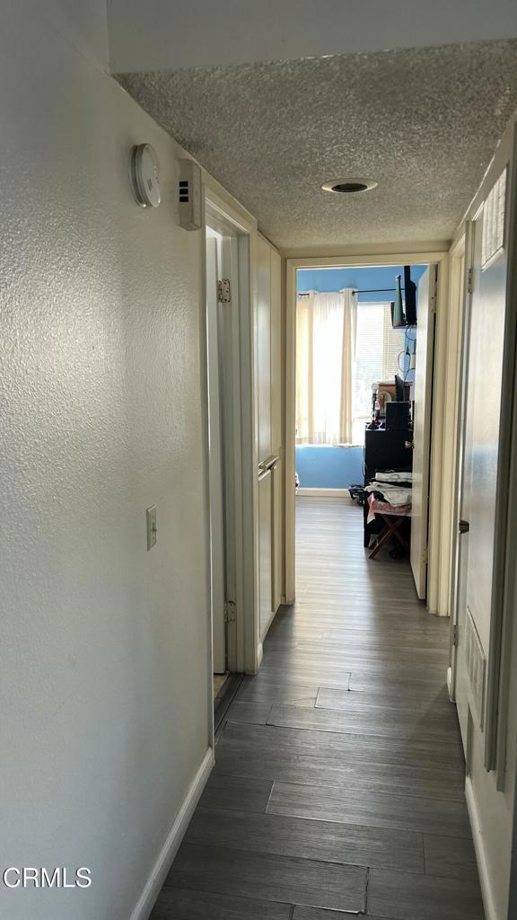 5215 Jefferson Square Oxnard, CA 93033 - Photo 7 of 12 a view of a hallway with wooden floor and furniture
