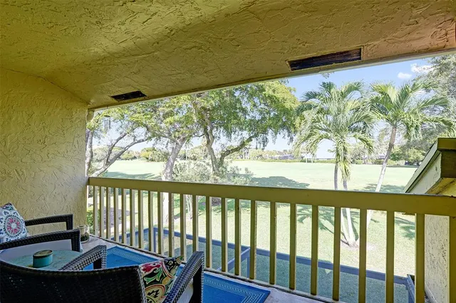 a view of a porch with furniture and a yard
