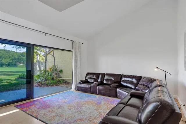 a living room with furniture and a floor to ceiling window