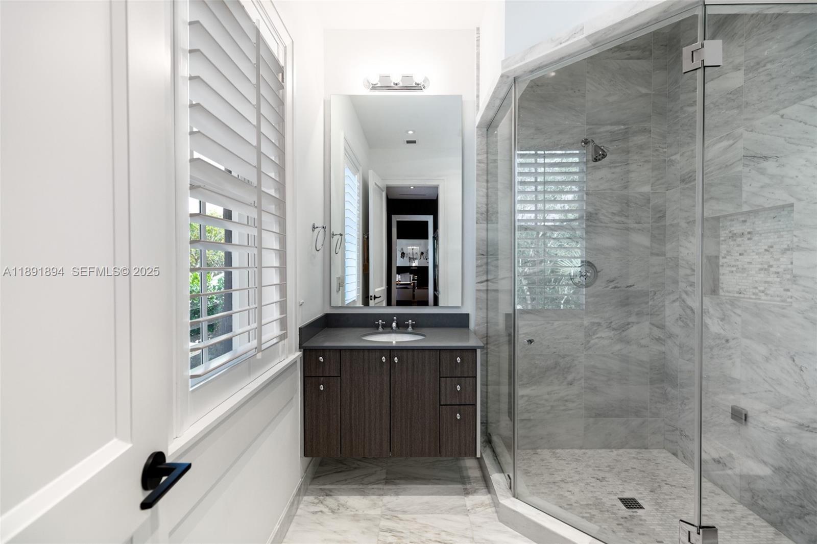 8150 School House Road Miami, FL 33143 - Photo 21 of 27 a bathroom with a shower and a sink