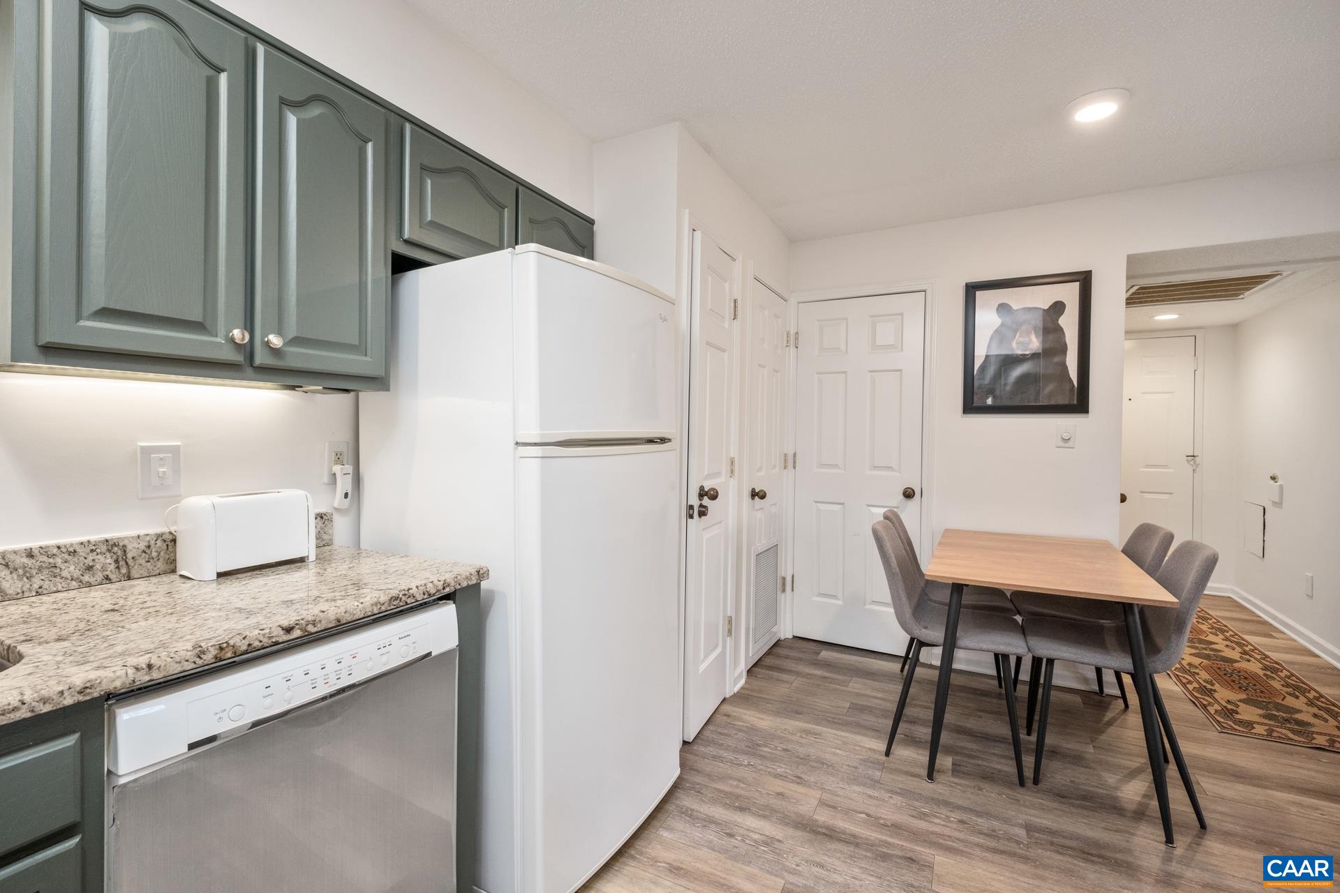 2028 Stone Ridge Roseland, VA 22967 - Photo 9 of 23 a kitchen with granite countertop a refrigerator a stove a sink a dining table and chairs