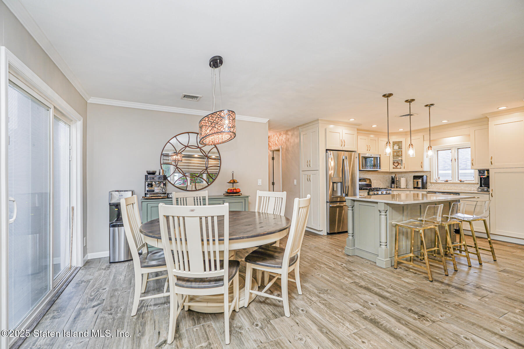 82 Woods Of Arden Road Staten Island, NY 10312 - Photo 11 of 30 a view of a dining room with furniture and wooden floor