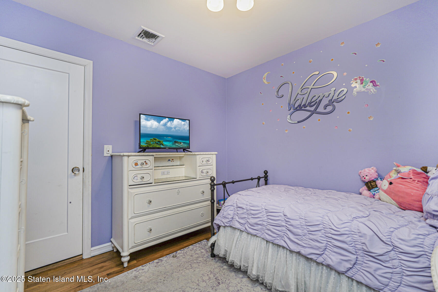 82 Woods Of Arden Road Staten Island, NY 10312 - Photo 16 of 30 a bedroom with a bed and a television in it