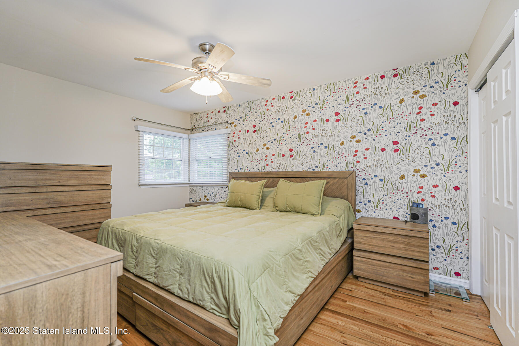 82 Woods Of Arden Road Staten Island, NY 10312 - Photo 17 of 30 a bedroom with a bed and a chandelier