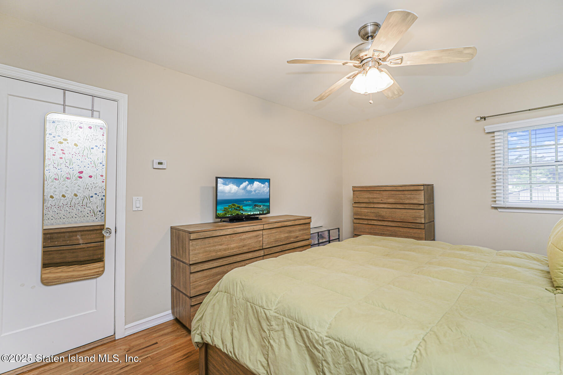 82 Woods Of Arden Road Staten Island, NY 10312 - Photo 18 of 30 a bedroom with a bed and a window