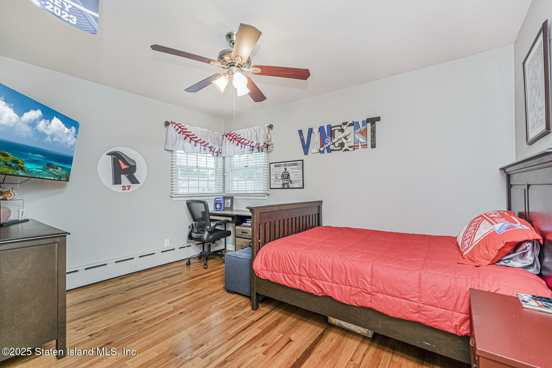 82 Woods Of Arden Road Staten Island, NY 10312 - Photo 19 of 30 a bedroom with a bed and a chandelier