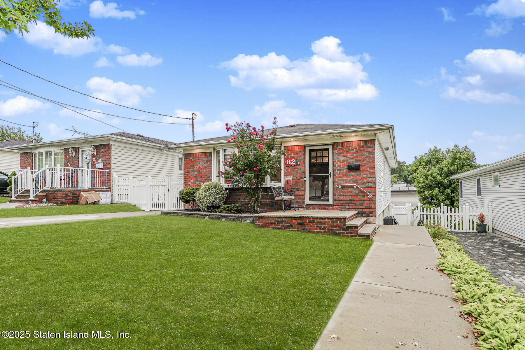82 Woods Of Arden Road Staten Island, NY 10312 - Photo 2 of 30 a front view of a house with garden