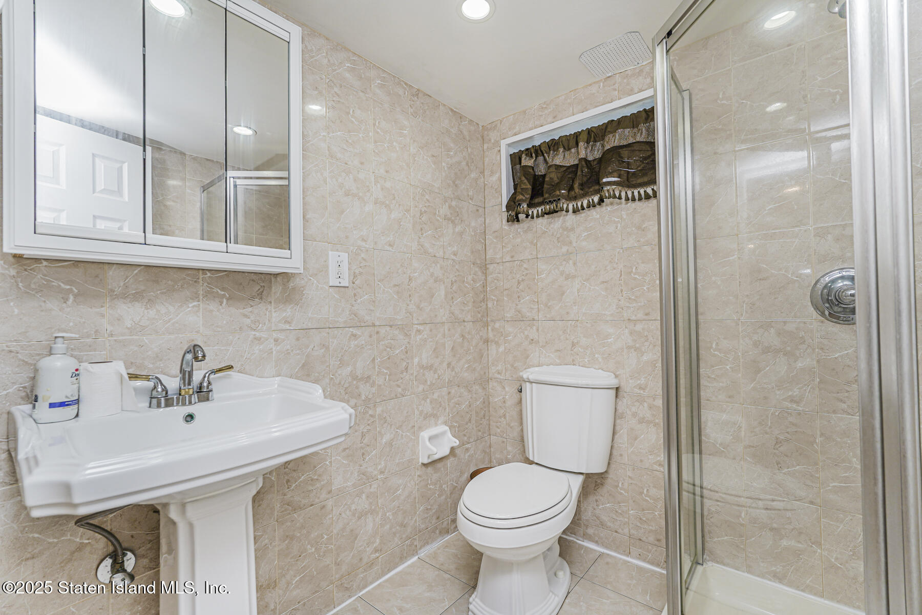 82 Woods Of Arden Road Staten Island, NY 10312 - Photo 21 of 30 a bathroom with a sink toilet and shower