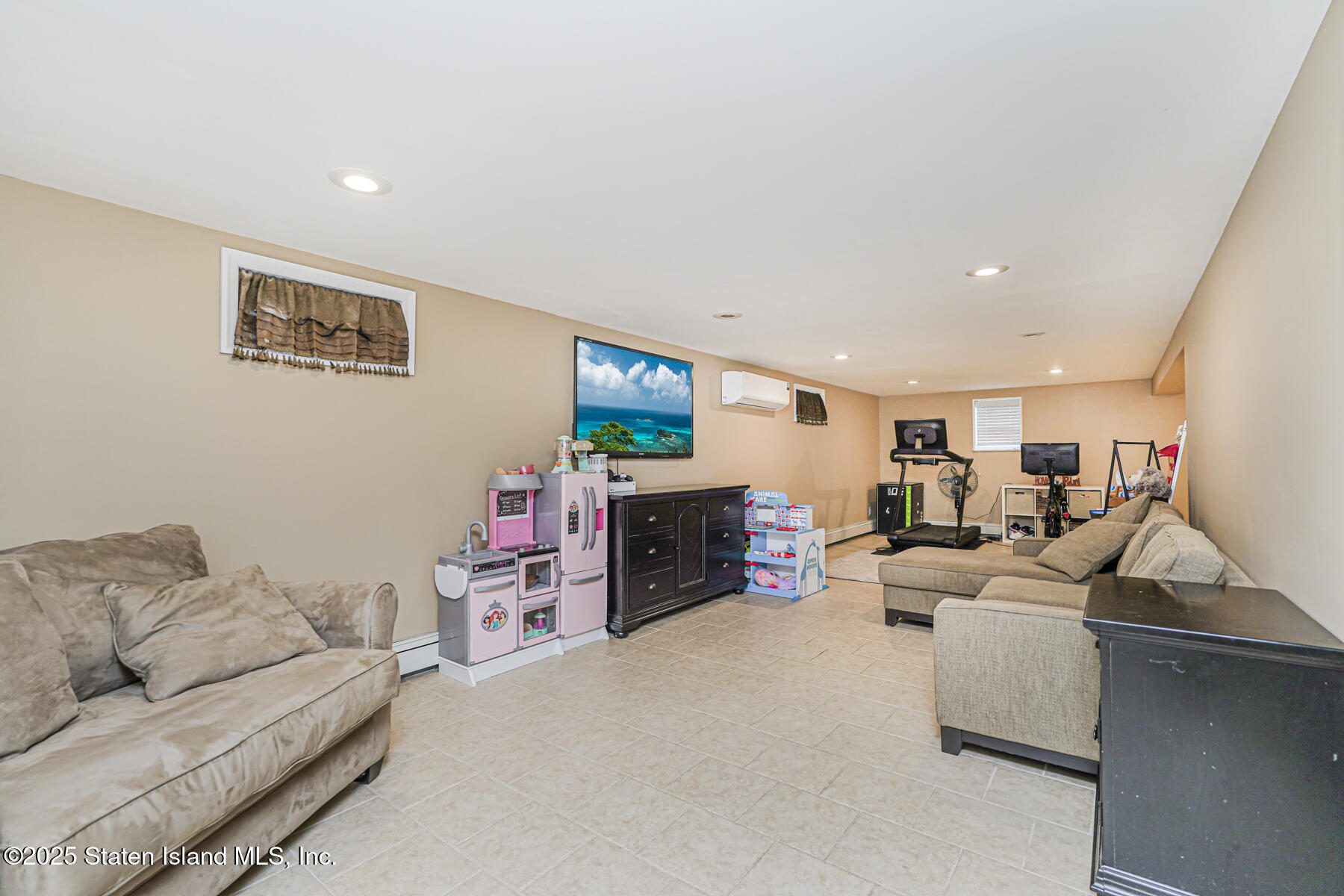 82 Woods Of Arden Road Staten Island, NY 10312 - Photo 24 of 30 a living room with furniture and a flat screen tv