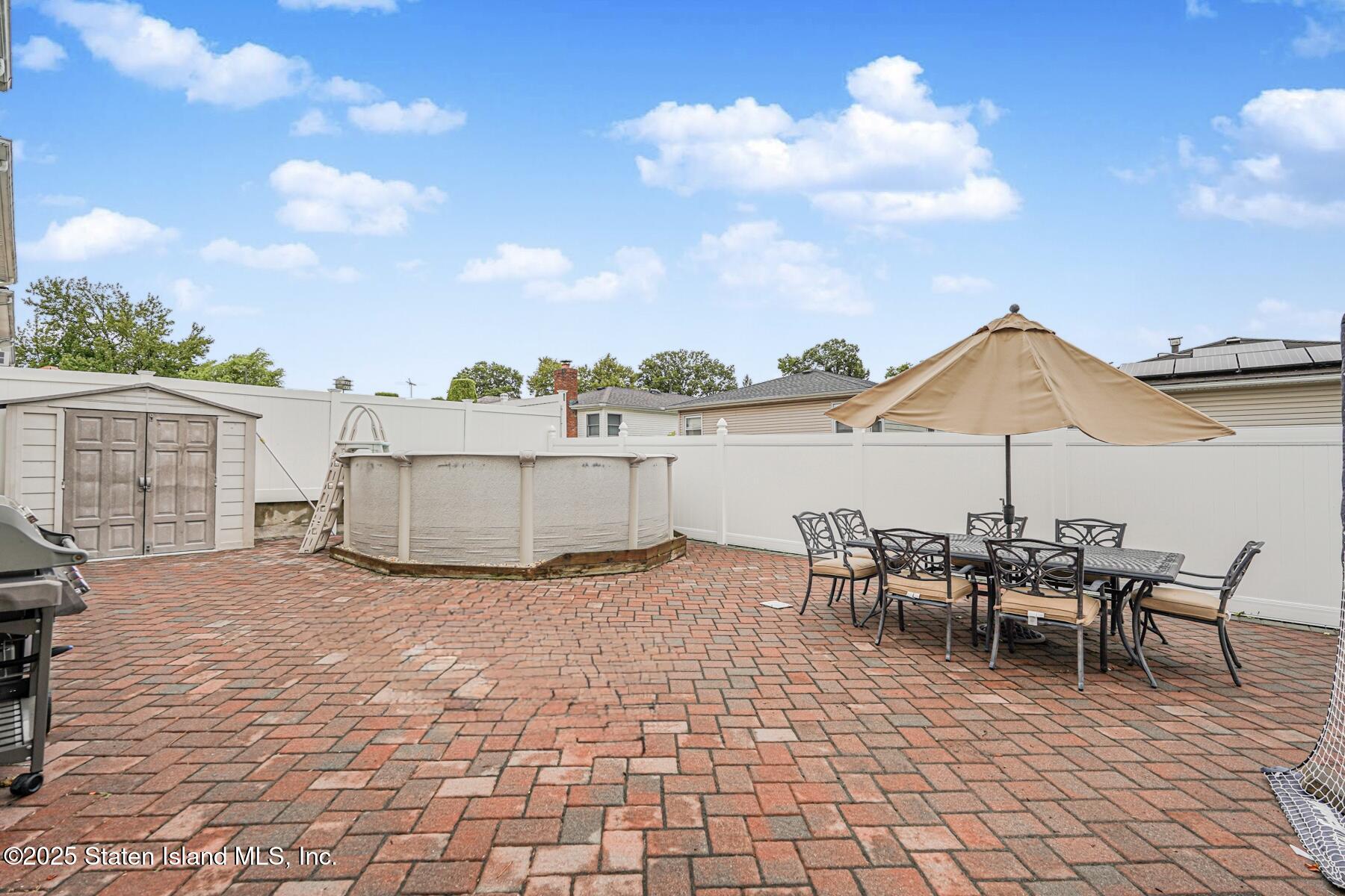 82 Woods Of Arden Road Staten Island, NY 10312 - Photo 26 of 30 a view of a patio with table and chairs
