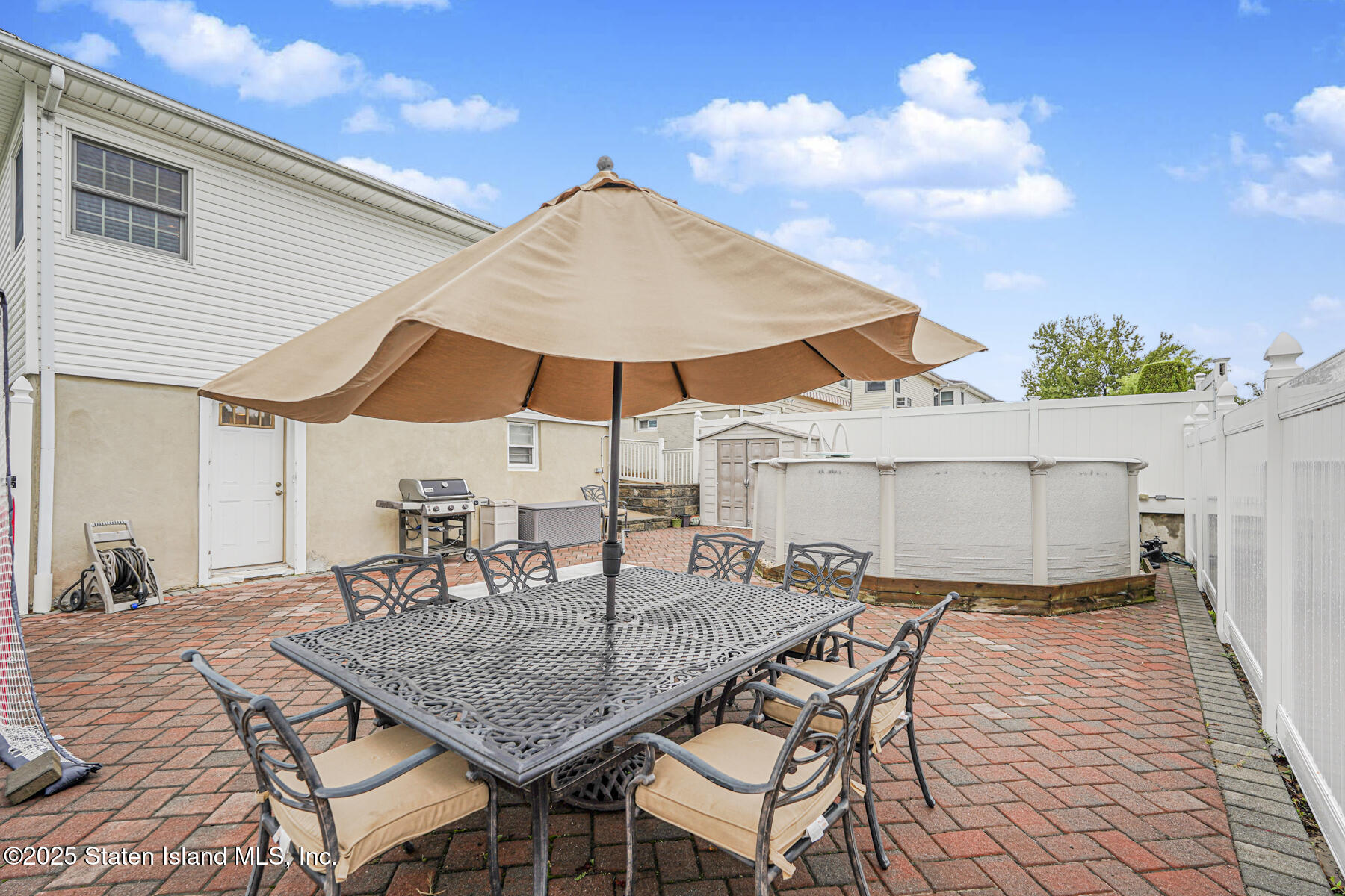 82 Woods Of Arden Road Staten Island, NY 10312 - Photo 27 of 30 an outdoor space with furniture and umbrella