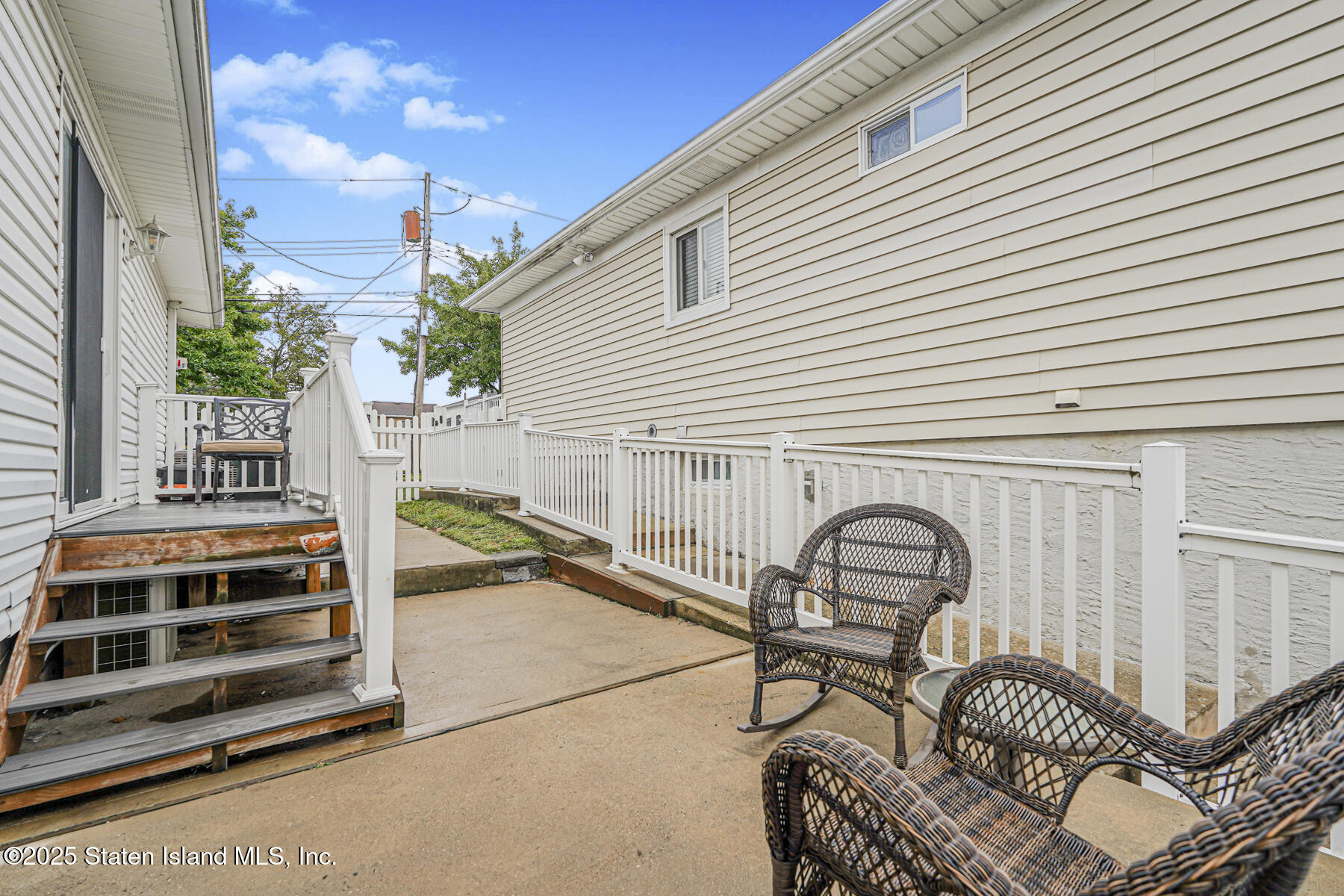 82 Woods Of Arden Road Staten Island, NY 10312 - Photo 30 of 30 a view of a patio with a table and chairs and a barbeque