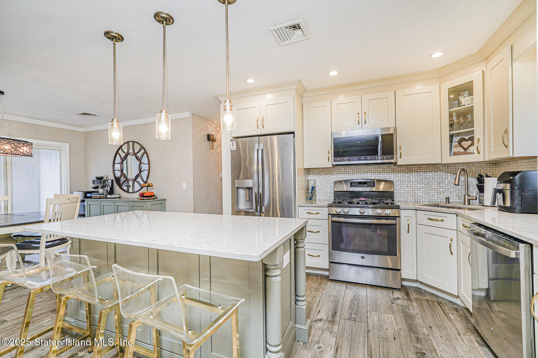82 Woods Of Arden Road Staten Island, NY 10312 - Photo 9 of 30 a kitchen with kitchen island white cabinets and stainless steel appliances
