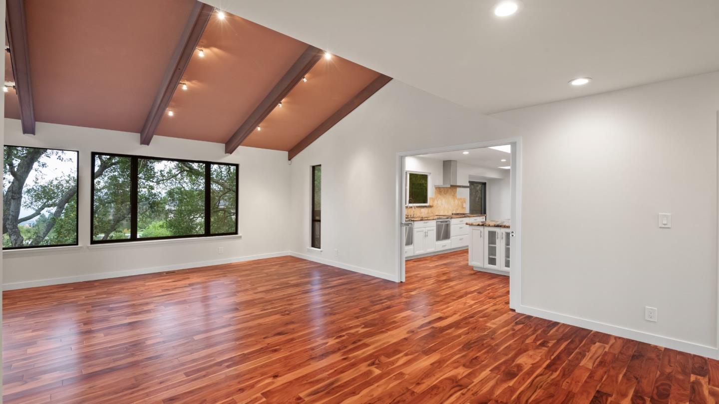 16353 Aztec Ridge Drive Los Gatos, CA 95030 - Photo 31 of 61 a view of a big room with wooden floor and windows