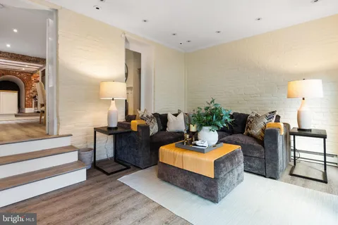 a living room with furniture flowerpot and a window