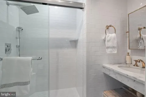 a living room with furniture a rug and white walls