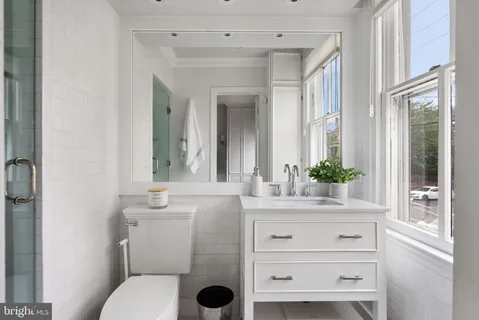 a view of a patio with table and chairs with wooden floor and fence