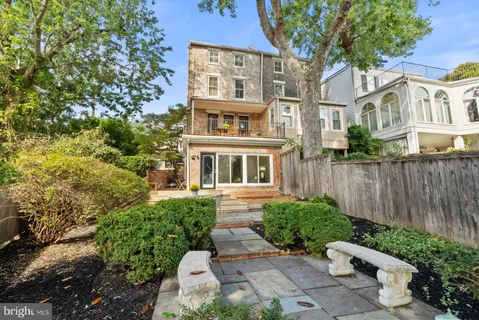 a view of a room with a large window and front door