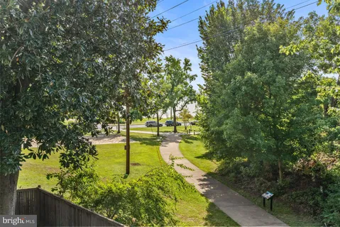 a view of a hallway and a livingroom with wooden floor