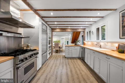 a view of a balcony with chairs and a potted plant