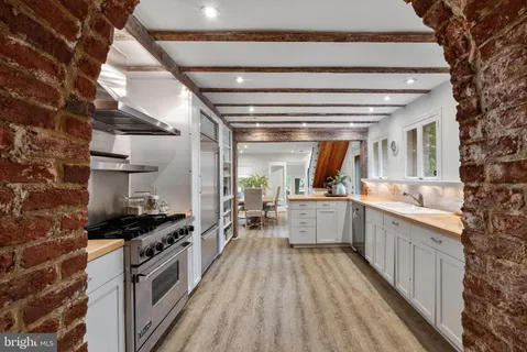a kitchen with stove and cabinets