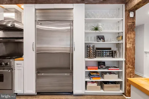 a living room with furniture a flat screen tv and a floor to ceiling window