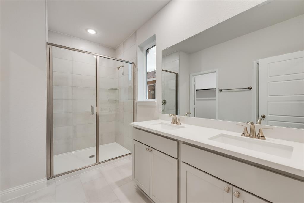 1013 Canoe Way Crowley, TX 76036 - Photo 17 of 26 a bathroom with a shower sink and mirror