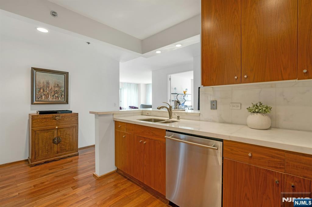 3219 City Place Edgewater, NJ 07020 - Photo 11 of 28 a spacious bathroom with a granite countertop sink and a mirror