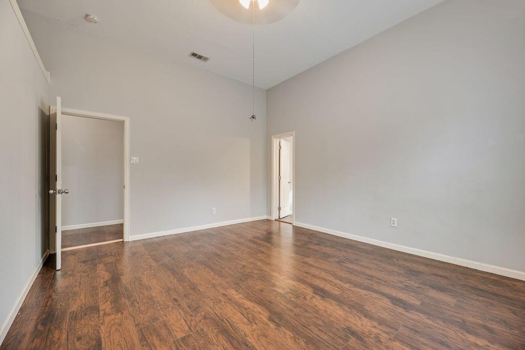 500 East Main Street Denison, TX 75021 - Photo 19 of 21 Unfurnished room with a high ceiling and dark wood-style floors