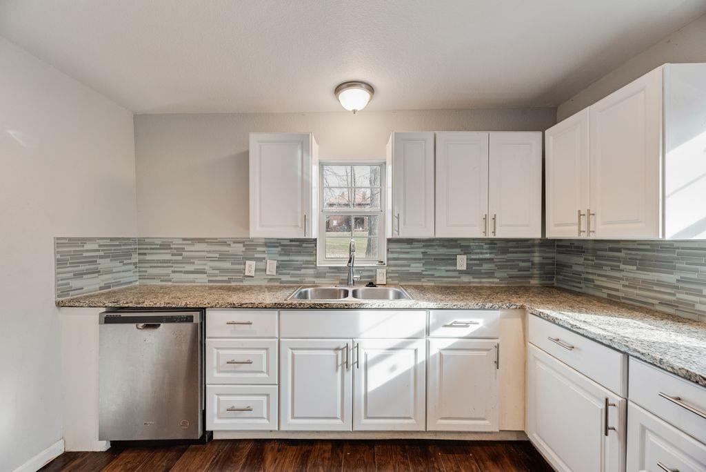 500 East Main Street Denison, TX 75021 - Photo 3 of 21 Kitchen featuring white cabinets, dishwasher, and dark wood finished floors
