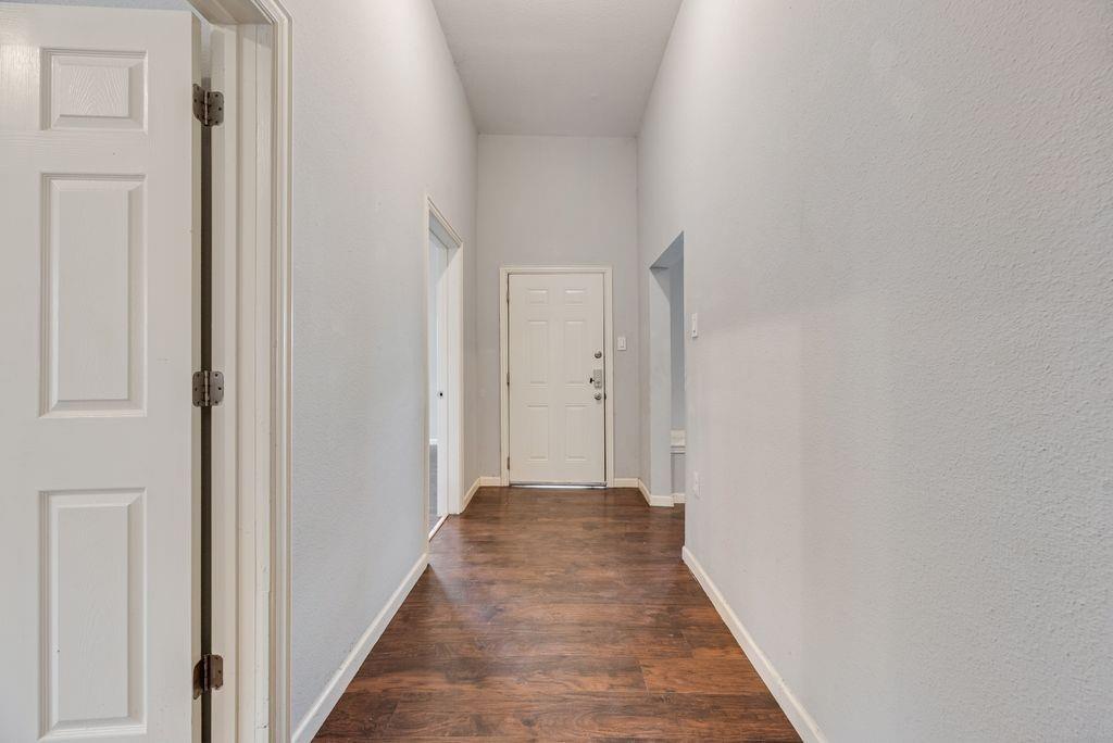 500 East Main Street Denison, TX 75021 - Photo 5 of 21 Hallway featuring dark wood finished floors and arched walkways