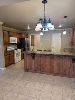 6801 Mosley Street Amarillo, TX 79119 - Photo 3 of 12 a view of a kitchen with a sink and microwave