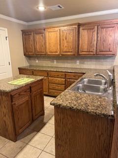 6801 Mosley Street Amarillo, TX 79119 - Photo 4 of 12 a kitchen with a sink and cabinets
