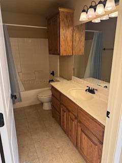 6801 Mosley Street Amarillo, TX 79119 - Photo 10 of 12 a bathroom with a sink a toilet and shower